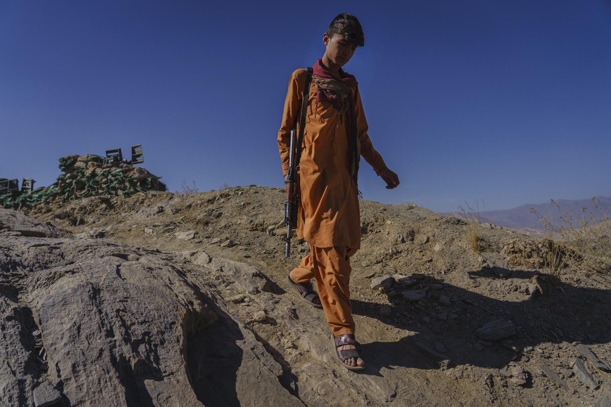  A boy with a weapon patrols an outpost.