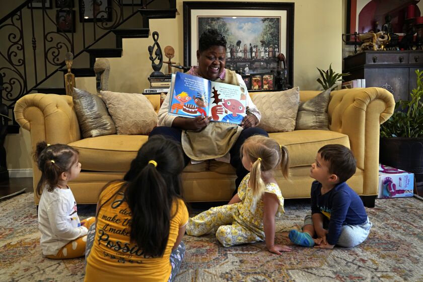 Los Angeles, California-Dr. Tenika Jackson, LGBT Specialization Director and psychologist at Antioch University in L.A. reads a story called "The Skin You Live In," about inclusion and acceptance to the pre-school children in her care. Dr. Jackson works with LGBTQ youth and families and knows first-hand as a lesbian with children of her own how important it is to create safe and affirming classroom settings for kids. (Carolyn Cole / Los Angeles Times)