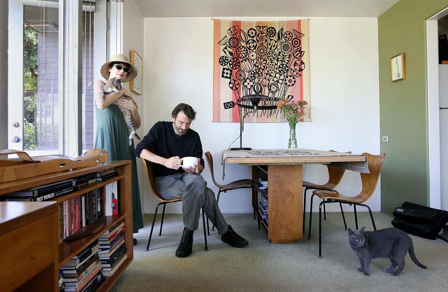 Architect John Bertram has restored Neutra homes in his practice and designs homes that bear the influence of Neutra. He also lives in a Neutra house in Silver Lake. The dining area is just off the kitchen. Neutra's built-in table is composed of a Douglas fir pedestal and a 1.5-inch laminated plywood top, a replacement for the original. The cat Christy Turlington pauses on the wall-to-wall carpeting in a garden green, Bertram and wife Ann Magnuson's favorite color, which also appears on accent walls in the dining and living areas. Full gallery