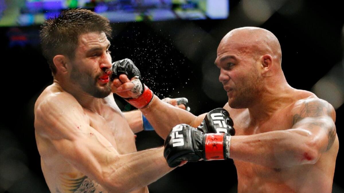 Robbie Lawler hits Carlos Condit with a right hand during their bout at UFC 195 in Las Vegas on Jan. 2.