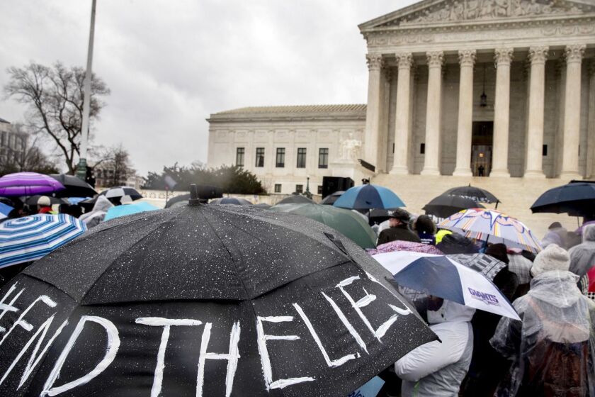 A pro-abortion rights supporter holds an umbrella that reads "#EndTheLies" during a rally outside the Supreme Court in Washington, Tuesday, March 20, 2018, as the Supreme Court hears arguments in a free speech fight over California's attempt to regulate anti-abortion crisis pregnancy centers. (AP Photo/Andrew Harnik)
