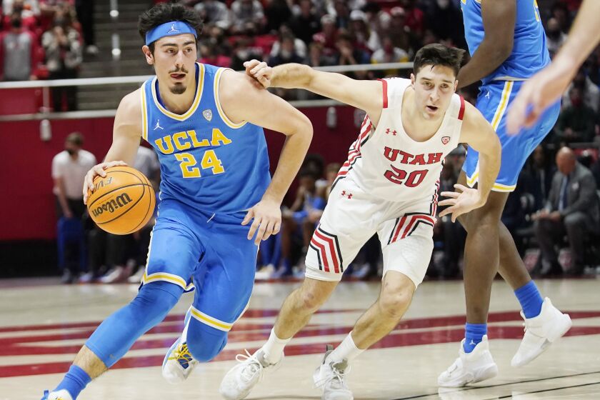 UCLA guard Jaime Jaquez Jr. (24) drives as Utah guard Lazar Stefanovic (20) defends.