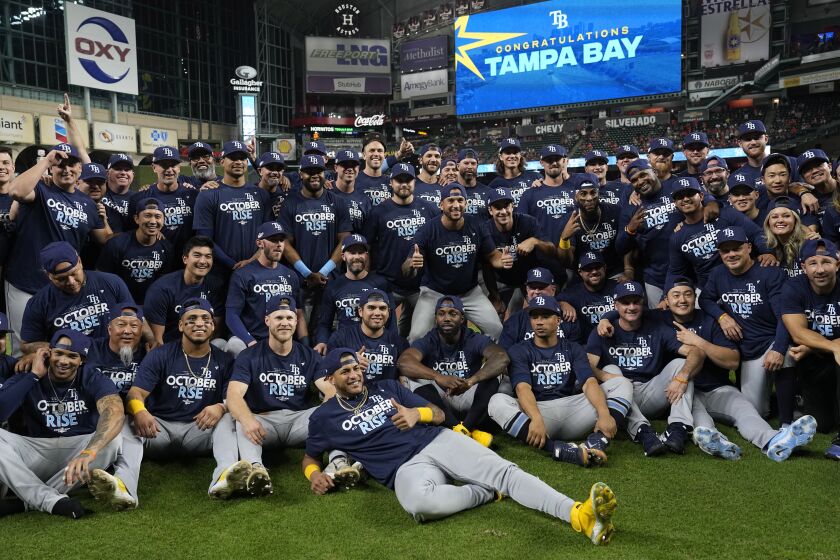 The Tampa Bay Rays pose for a team picture after a baseball game against the Houston Astros Friday, Sept. 30, 2022, in Houston. The Rays won 7-3 and clinched a postseason berth. (AP Photo/David J. Phillip)