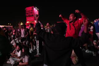 Fans cheer at the FIFA Fan Festival after a goal by Japan's Takuma Asano 