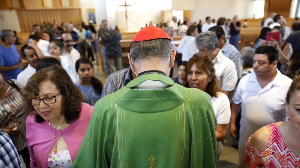 Cardinal Mahony greets parishioners after leading mass in Spanish at St. John Vianney Church in Hacienda Heights on a recent Sunday.