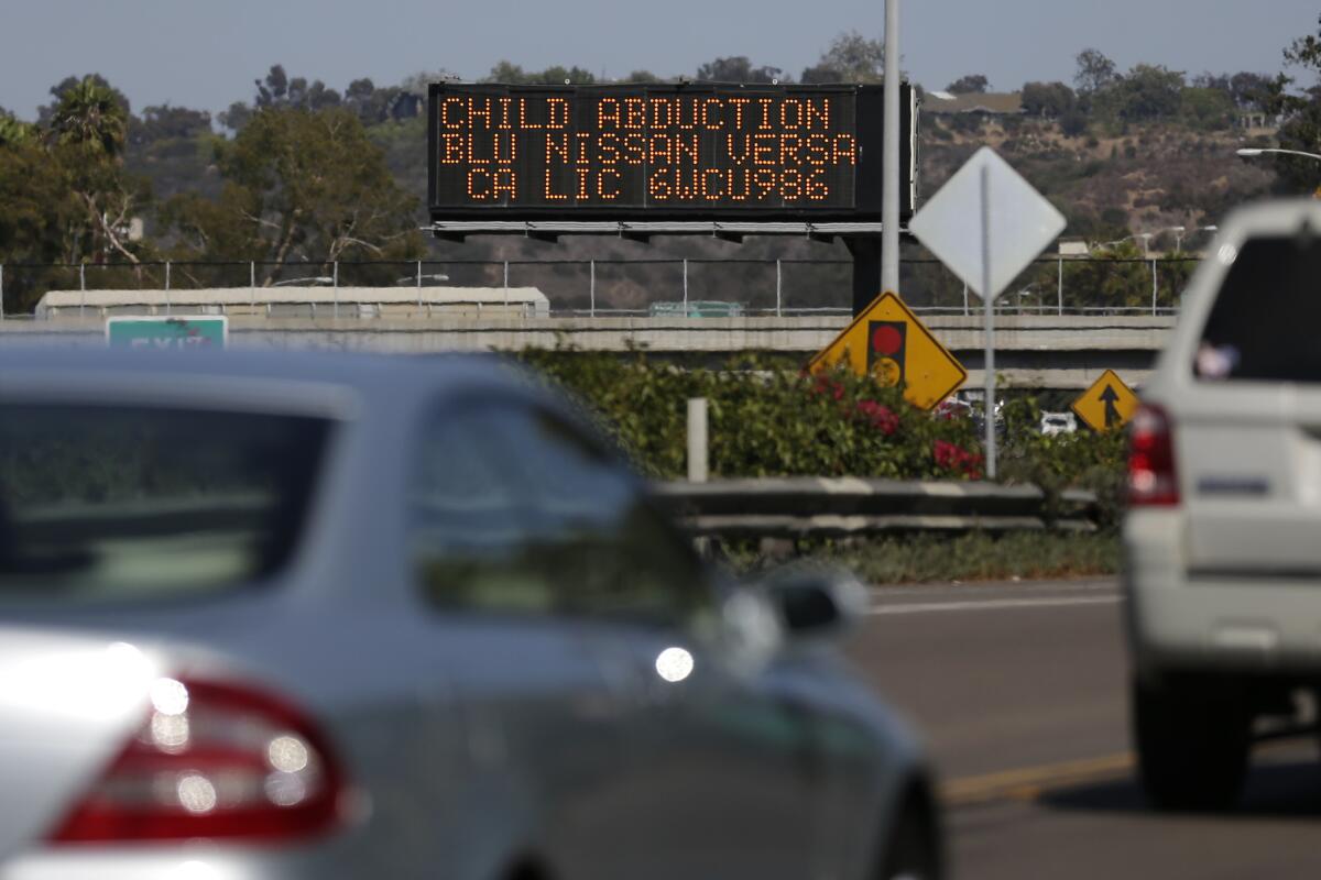 Drivers pass a display showing an Amber Alert asking motorists to be on the lookout for a specific vehicle in San Diego. The alert is now in effect in Oregon.