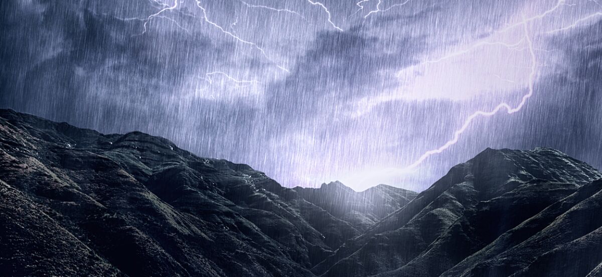 Shot of a dramatic thunderstorm over a mountain