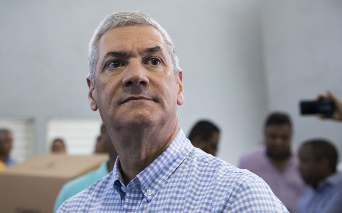 FILE - Presidential primary candidate Gonzalo Castillo, of with the Partido de la Liberacion Dominicana political party, arrives to vote during primary elections in Santo Domingo, Dominican Republic, Oct. 6, 2019. Authorities in the Dominican Republic have arrested 19 people in a sweeping corruption investigation that targeted Castillo and three ex government officials accused of illegal campaign financing. (AP Photo/Tatiana Fernandez, File)