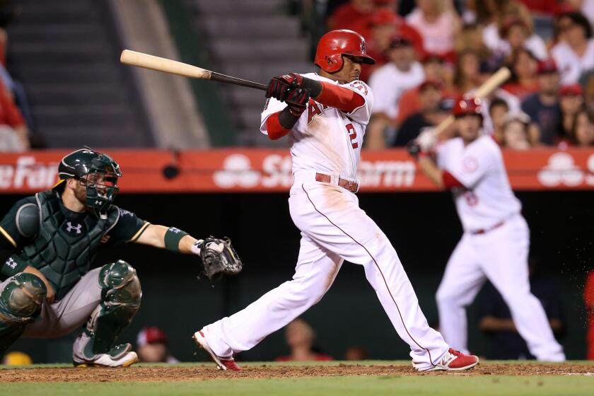 Erick Aybar drives in the first of two fourth-inning runs for the Angels against Oakland on Saturday night.