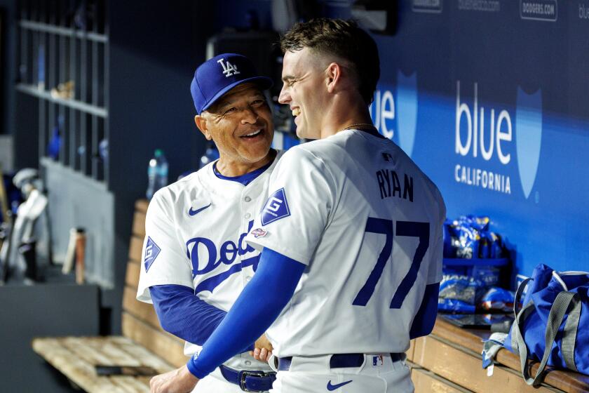 LOS ANGELES, CA - JULY 22, 2024: Dodgers manager congratulates Dodgers starting pitcher River Ryan.