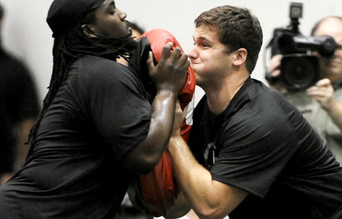 Texas A&M; offensive tackle Luke Joeckel, right, works during a blocking drill during pro day.