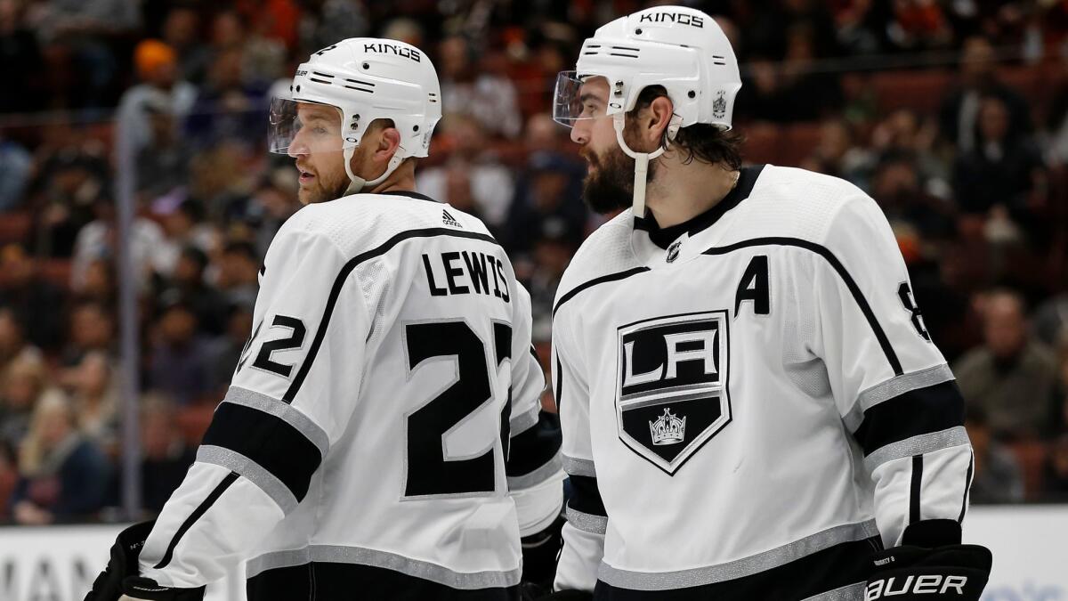 Center Trevor Lewis, left, and defenseman Drew Doughty will try to help the Kings beat the New York Rangers on Sunday night and end a losing streak at six games.
