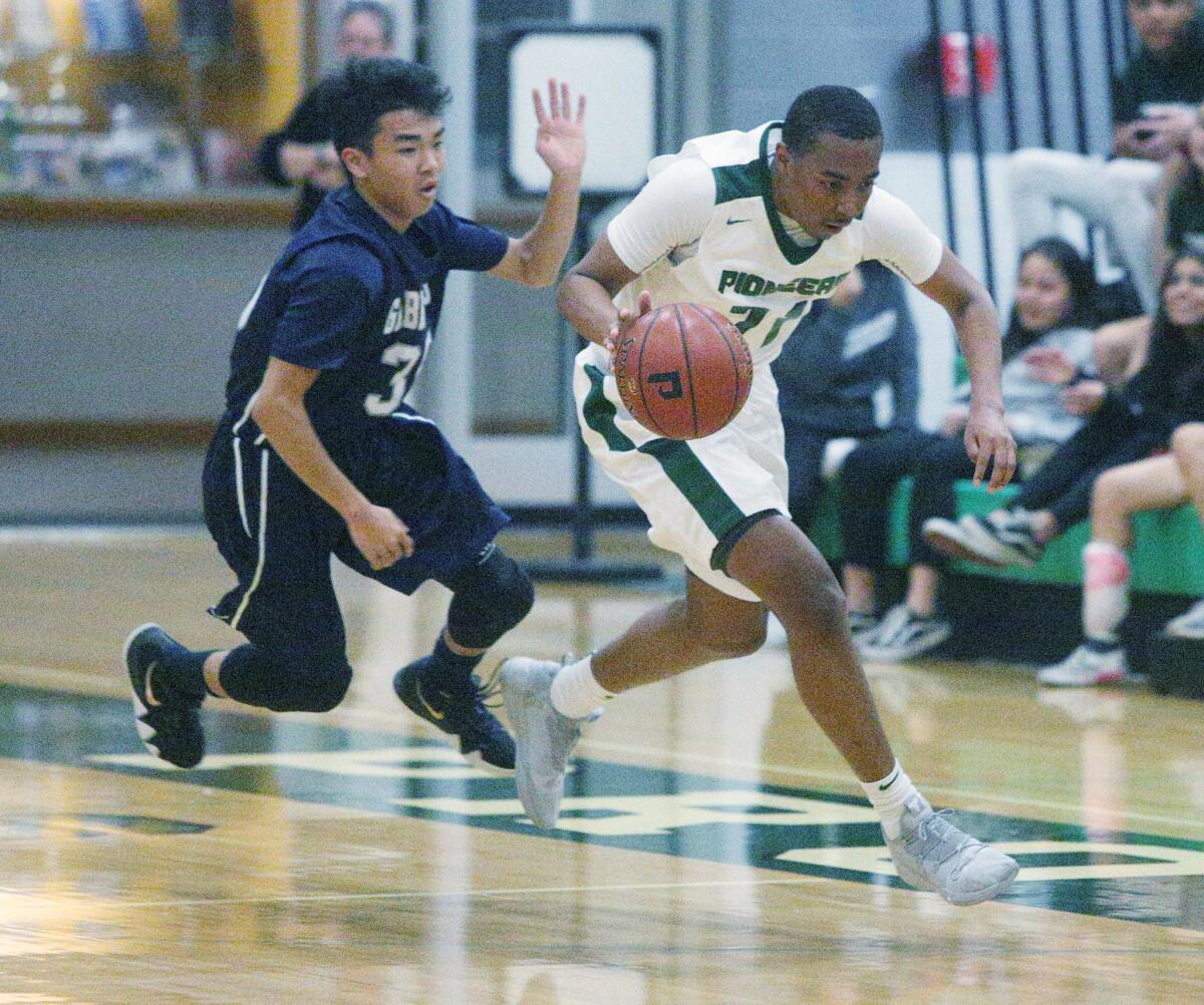 Providence's A'Jahni Levias, right, seen here in a file photo, scored 13 first half points for Providence against Flintridge Prep on Tuesday but was pulled in the third quarter following a hard foul.