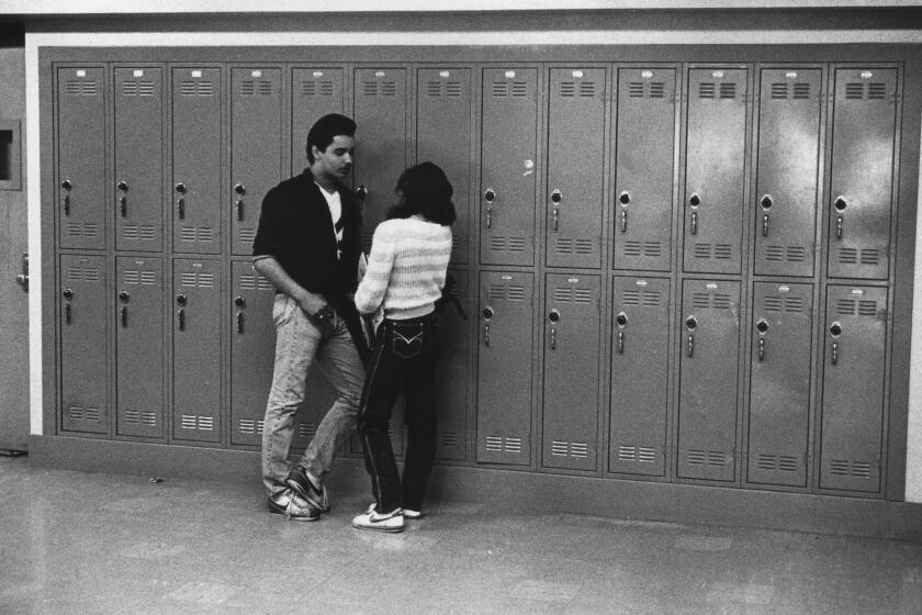 Images from the Los Angeles Times 1984 Pulitzer Prize Award for Public Service, "Latinos", a 27-part series on Southern California's latino community and culture in the early 1980s. Los Angeles, CA. L-R: Ralph Nejare and Letty Hernandez between classes at Garfield High School. (Los Angeles Times / Jose Galvez)