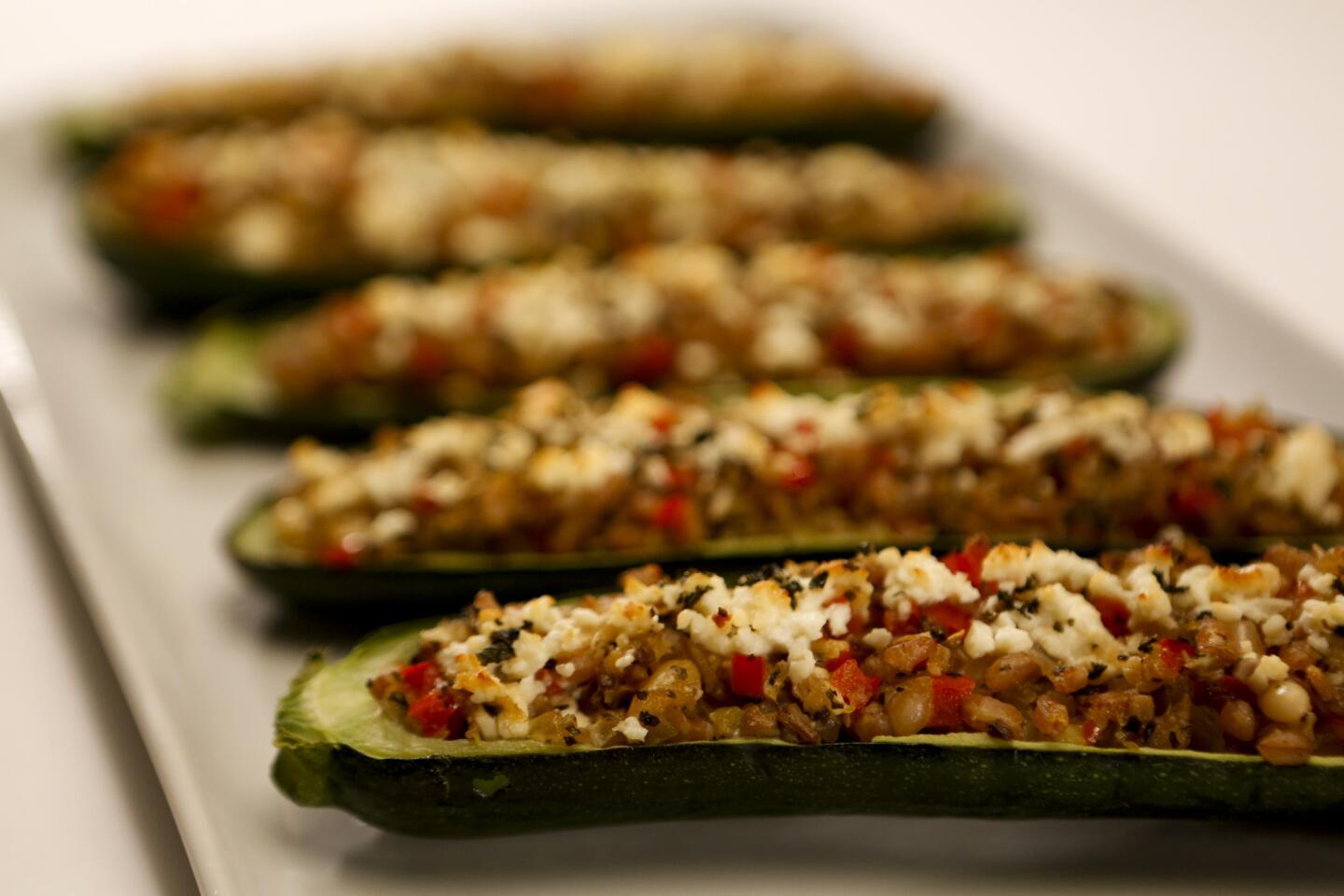 Zucchini stuffed with farro, red pepper and feta