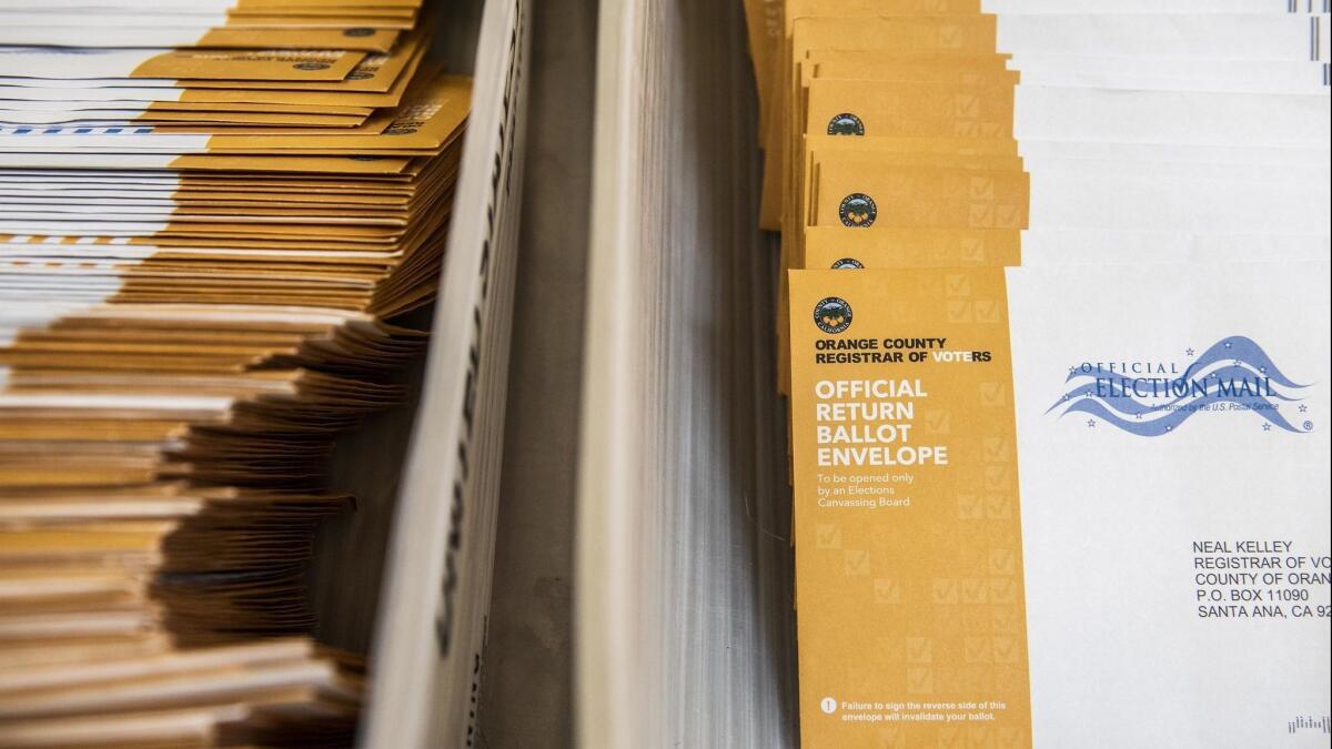 Mail-in ballots are readied to be counted at the Orange County Registrar of Voters on Nov. 7, 2018 in Santa Ana. State officials are now reviewing whether some ballots weren't counted due to a voter registration error at DMV offices.