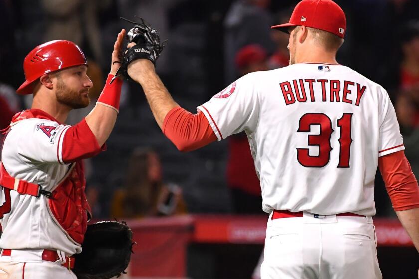 ANAHEIM, CA - MAY 01: Ty Buttrey #31 is greeted by catcher Jonathan Lucroy #20 of the Los Angeles Angels of Anaheim after earning a save in the ninth inning of the game against the Toronto Blue Jays at Angel Stadium of Anaheim on May 1, 2019 in Anaheim, California. (Photo by Jayne Kamin-Oncea/Getty Images) ** OUTS - ELSENT, FPG, CM - OUTS * NM, PH, VA if sourced by CT, LA or MoD **