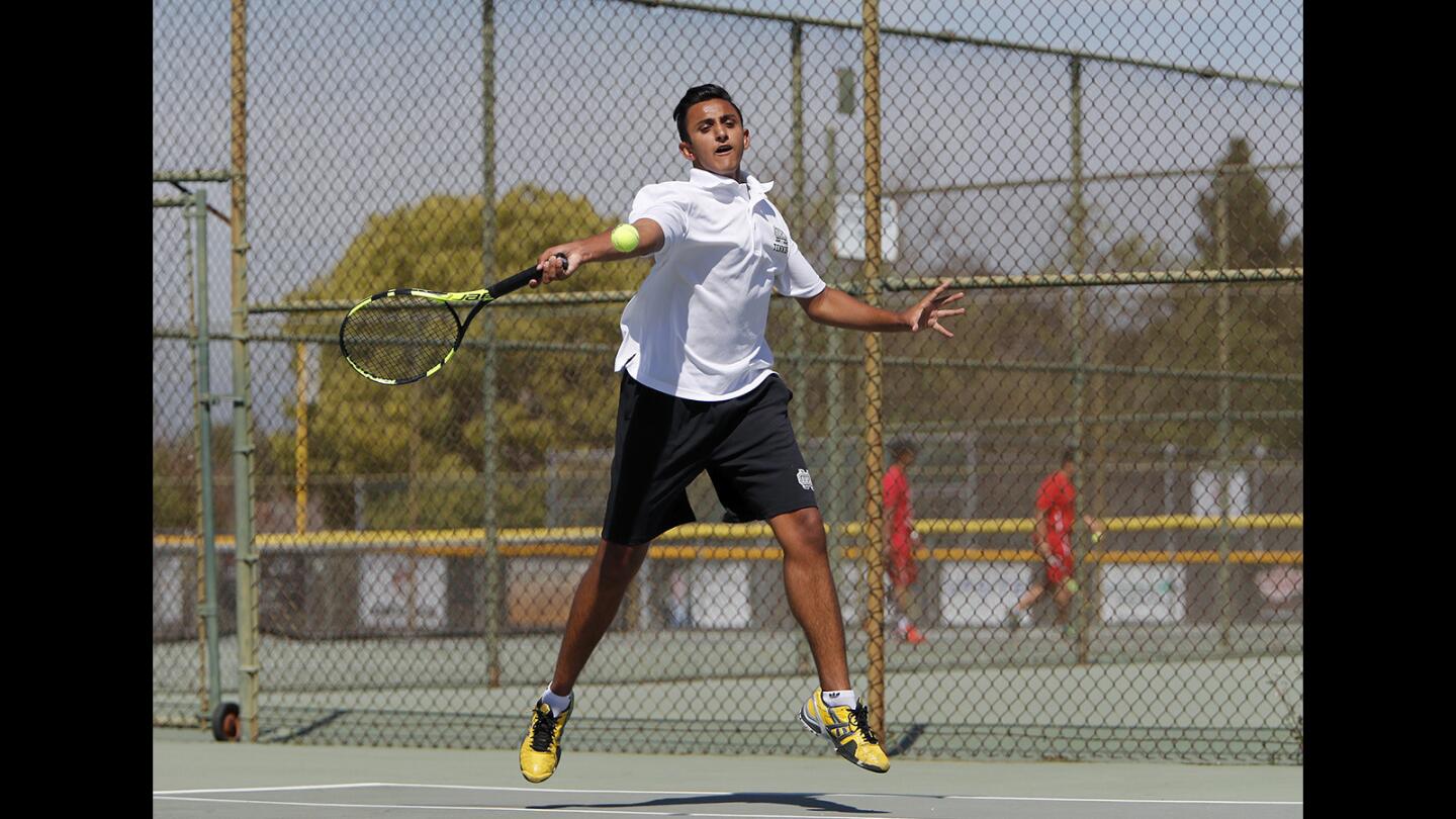 Costa Mesa High's Hritik Ronvelia competes against Santa Ana during a No. 1 singles set in an Orange Coast League match at Costa Mesa High on Thursday, April 18, 2019.