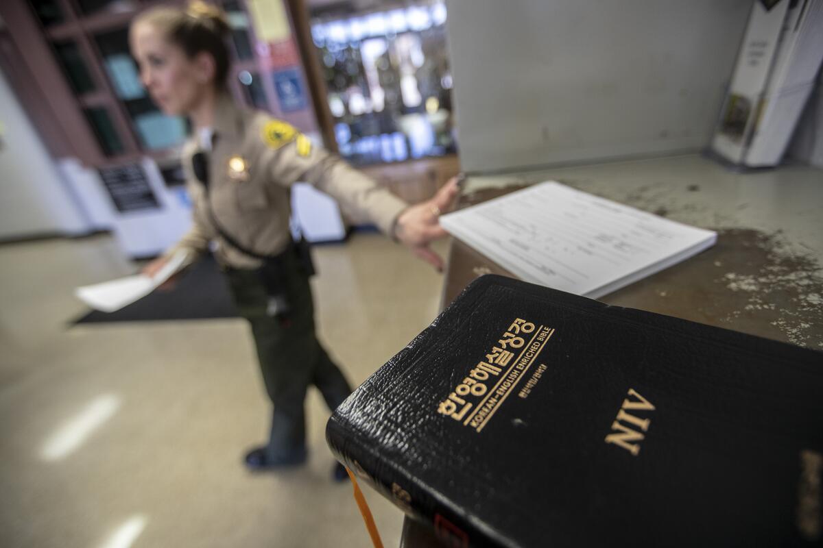 The Rev. Suk-ki Kim's Bible rests on a counter while he checks into North County Correctional Facility.
