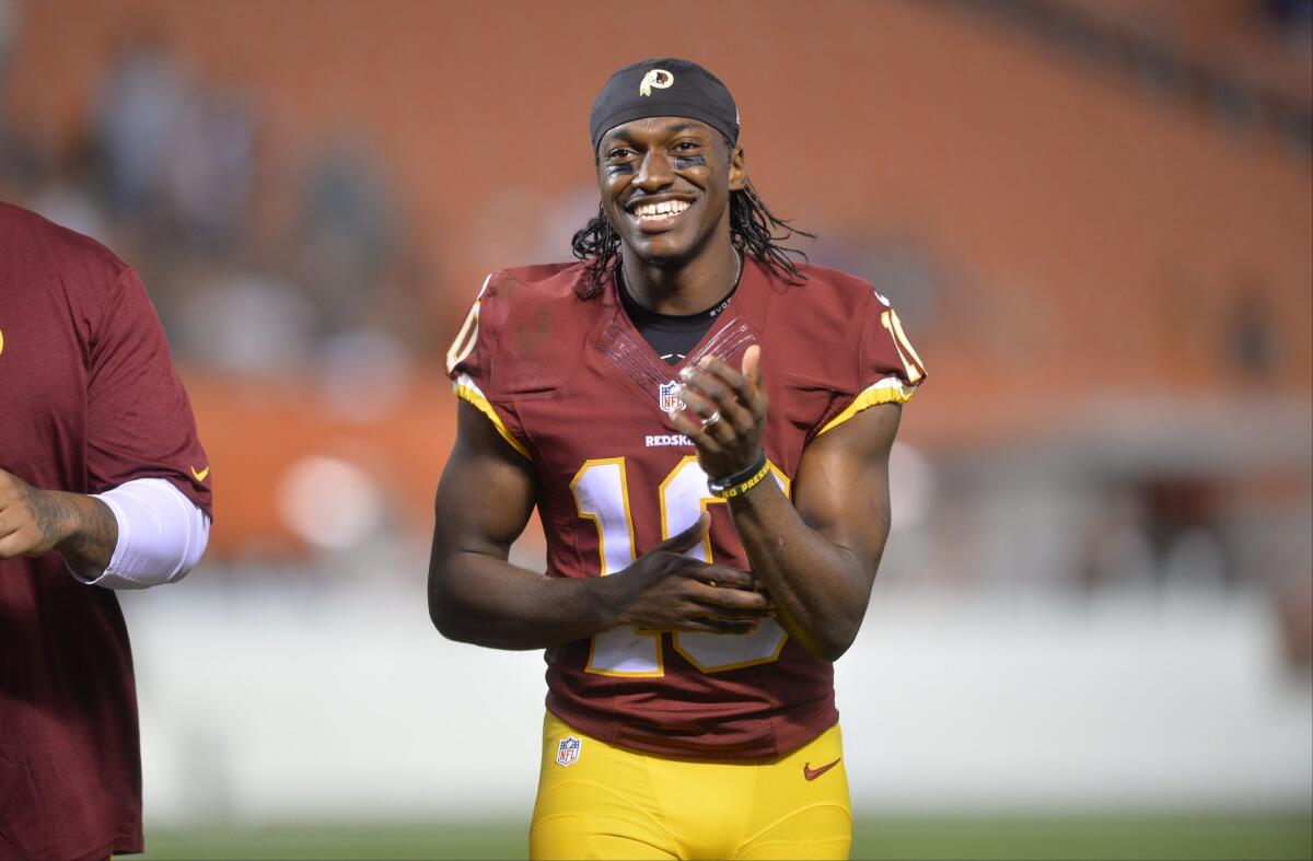 Washington quarterback Robert Griffin III smiles after the Redskins defeated the Cleveland Browns in a preseason football game Thursday.