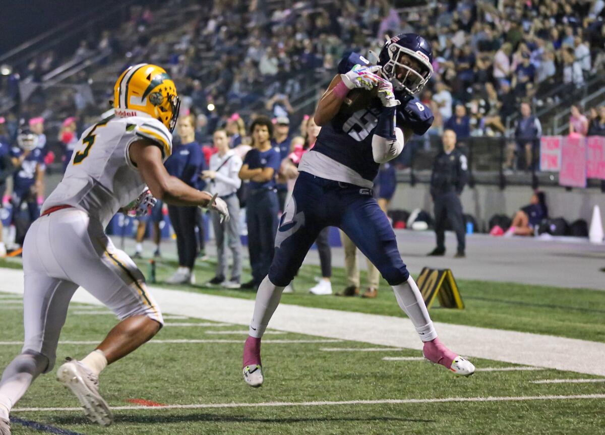 Newport Harbor receiver Josiah Lamarque (8) makes a catch just over the goal line for a touchdown against Edison on Friday.