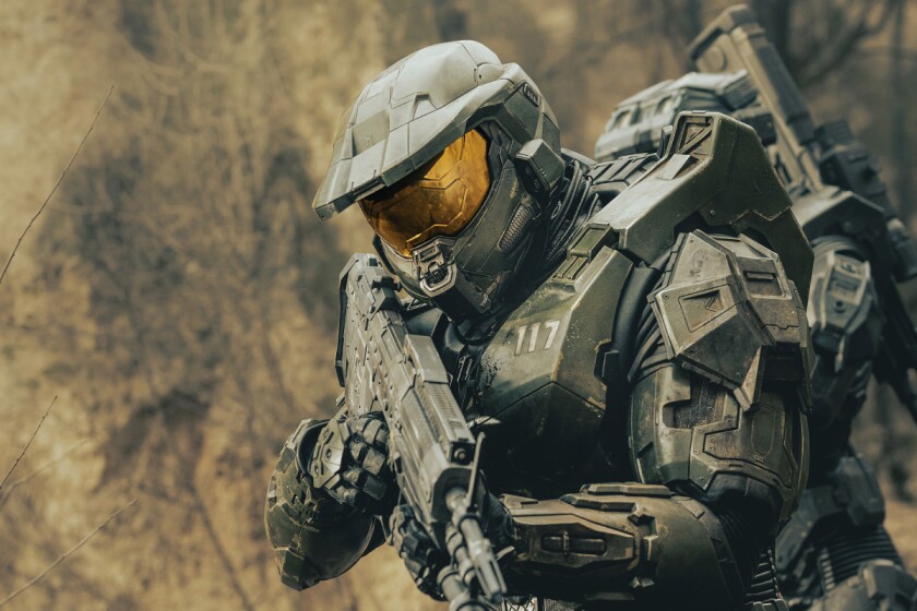 A soldier in armor holding a rifle