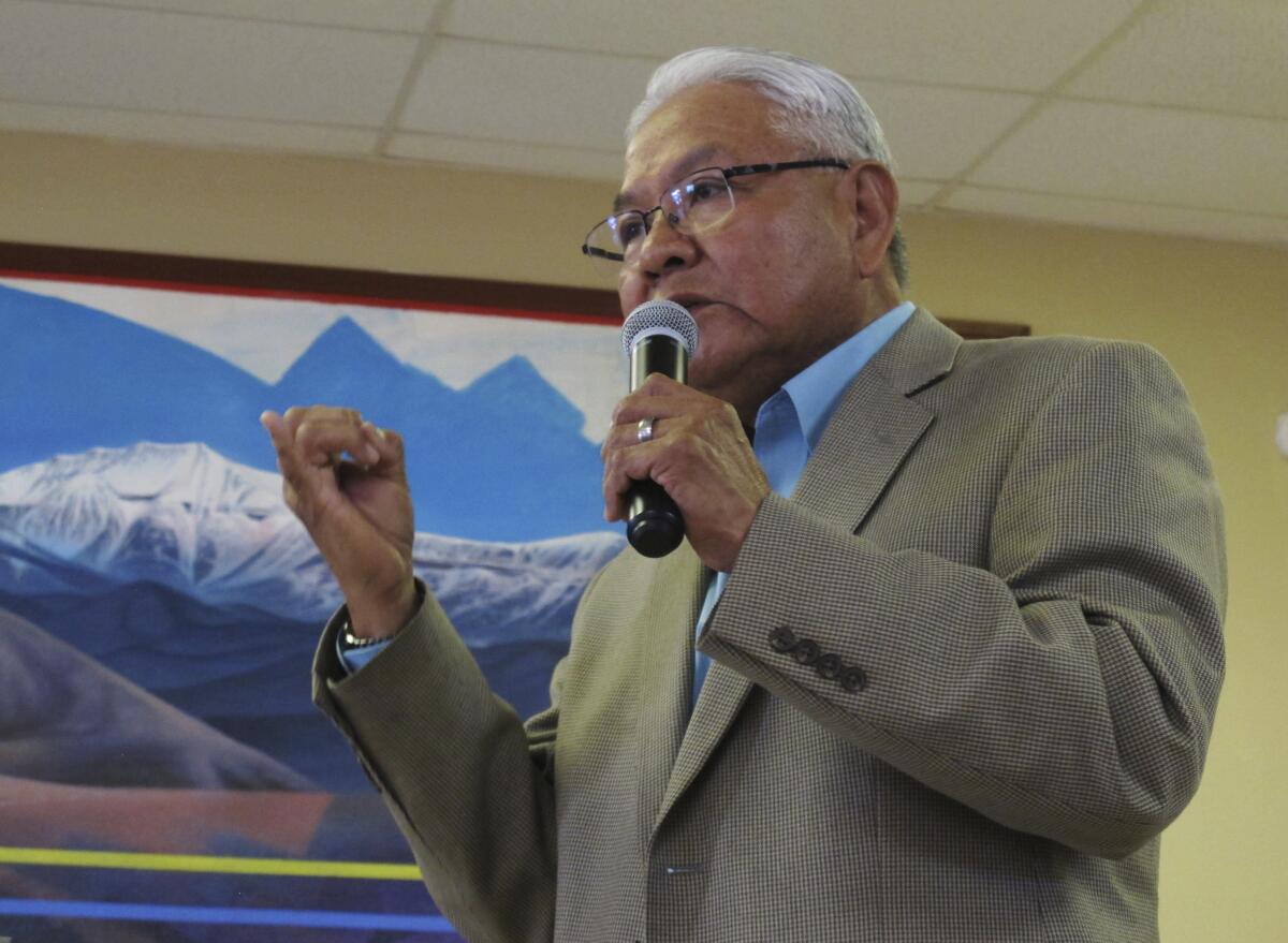 FILE - In this March 1, 2016 file photo Tommy Lewis, director of the Navajo Department of Dine Education, speaks at a public meeting, in Leupp, Ariz. Lewis, whose career spans decades in tribal communities and northern Arizona resigned from his latest post in Coconino County after officials discovered pornographic material on his work-issued computer, according to records obtained by The Associated Press. (AP Photo/Felicia Fonseca, File)