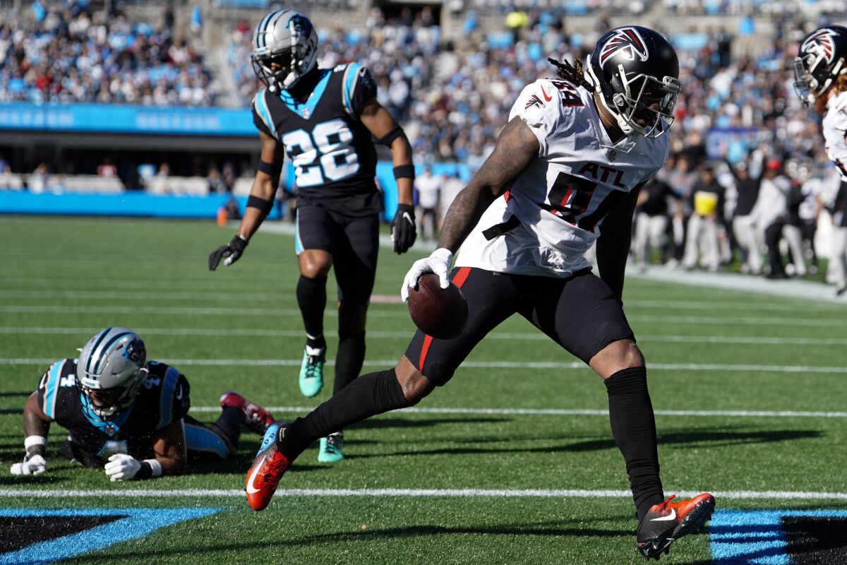 Atlanta Falcons running back Cordarrelle Patterson scores against the Carolina Panthers during the first half of an NFL football game Sunday, Dec. 12, 2021, in Charlotte, N.C. (AP Photo/Jacob Kupferman)