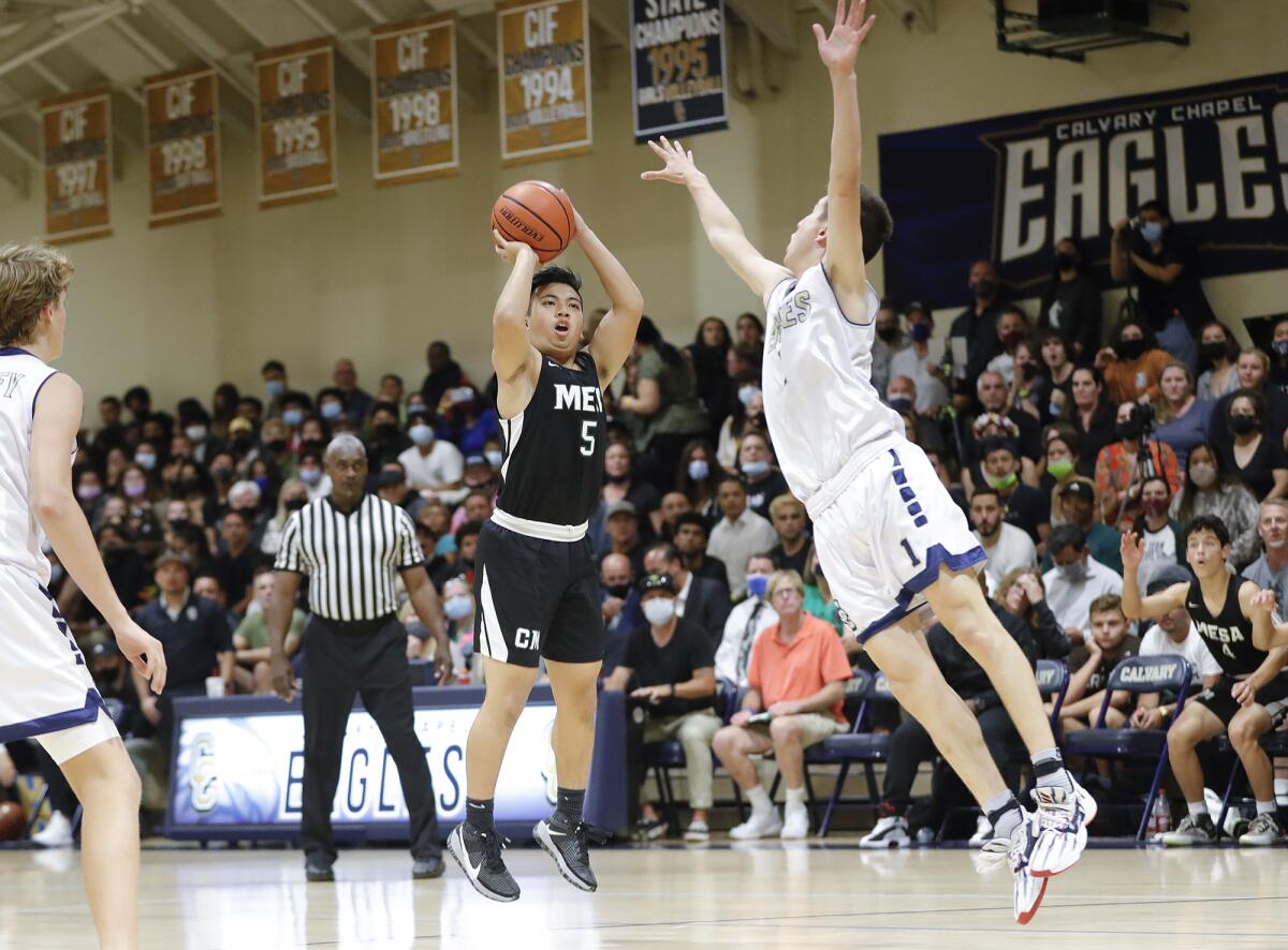 Costa Mesa's Christian Dasca (5) sinks a long basket during the CIF Southern Section Division 5AA boys' basketball final.