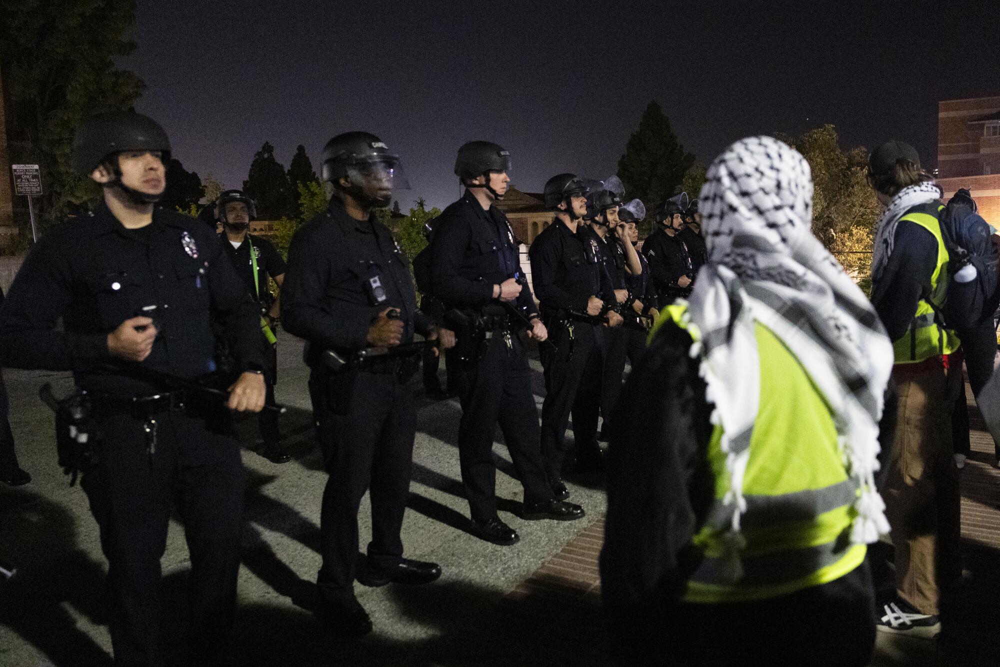 LAPD officers block protesters outside the encampment at UCLA's Royce Hall.