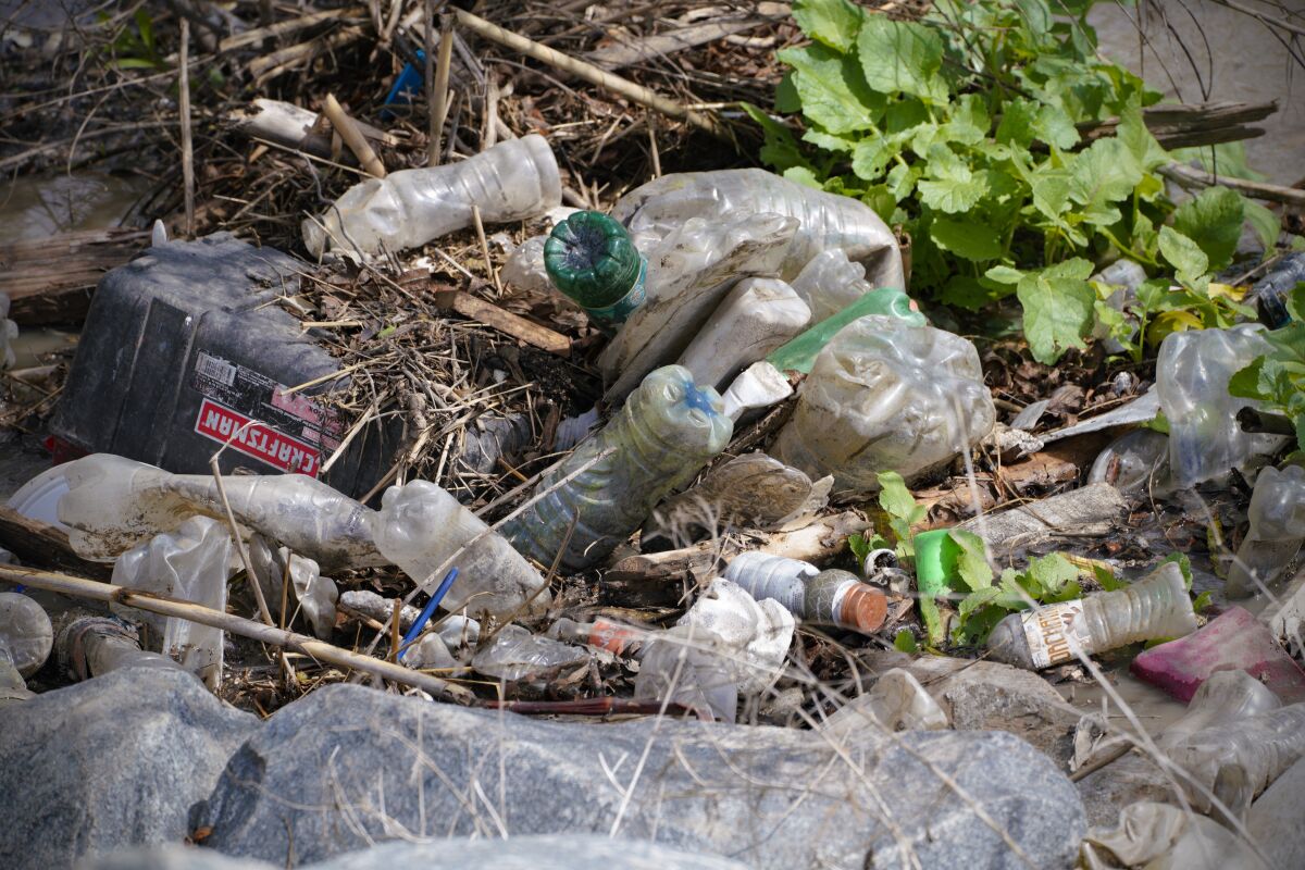  Trash debris and plastic bottles along the banks of the Tijuana River in this March 4, 2022 photo.