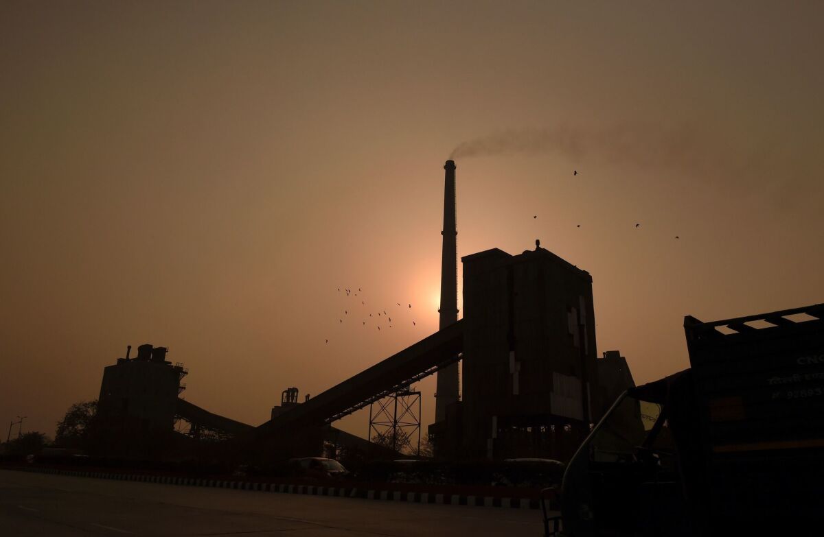 Scientists have proposed renaming the present geologic epoch of Earth to reflect human effects on the planet, such as the changed chemistry of the atmosphere brought about by burning of fossil fuels at factories such as this one in India.