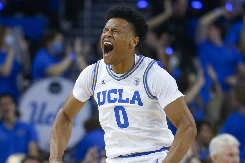 UCLA guard Jaylen Clark yells as he celebrates after scoring a 3-pointer against Arizona