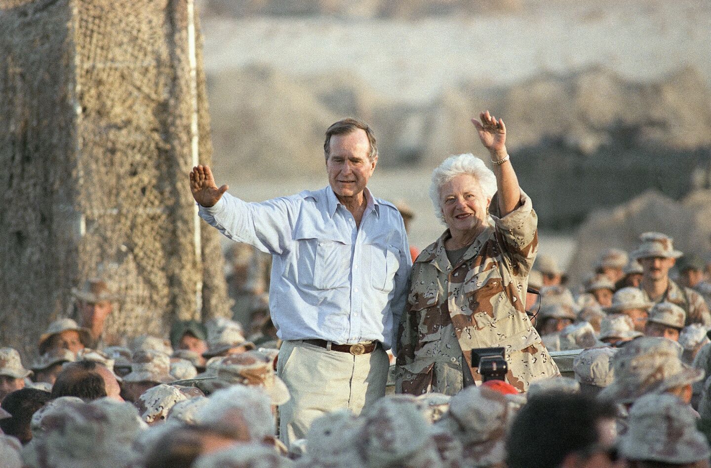 President George H.W. Bush and First Lady Barbara Bush greet Marines during a Thanksgiving visit in Saudi Arabia in 1990.