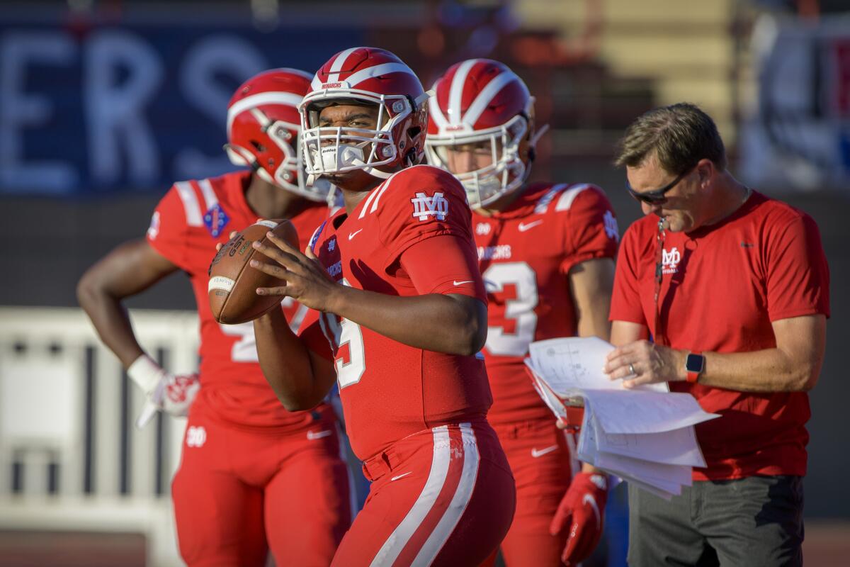 Santa Ana Mater Dei quarterback David Clark warms up before a game in Duncanville, Texas, on August 27.