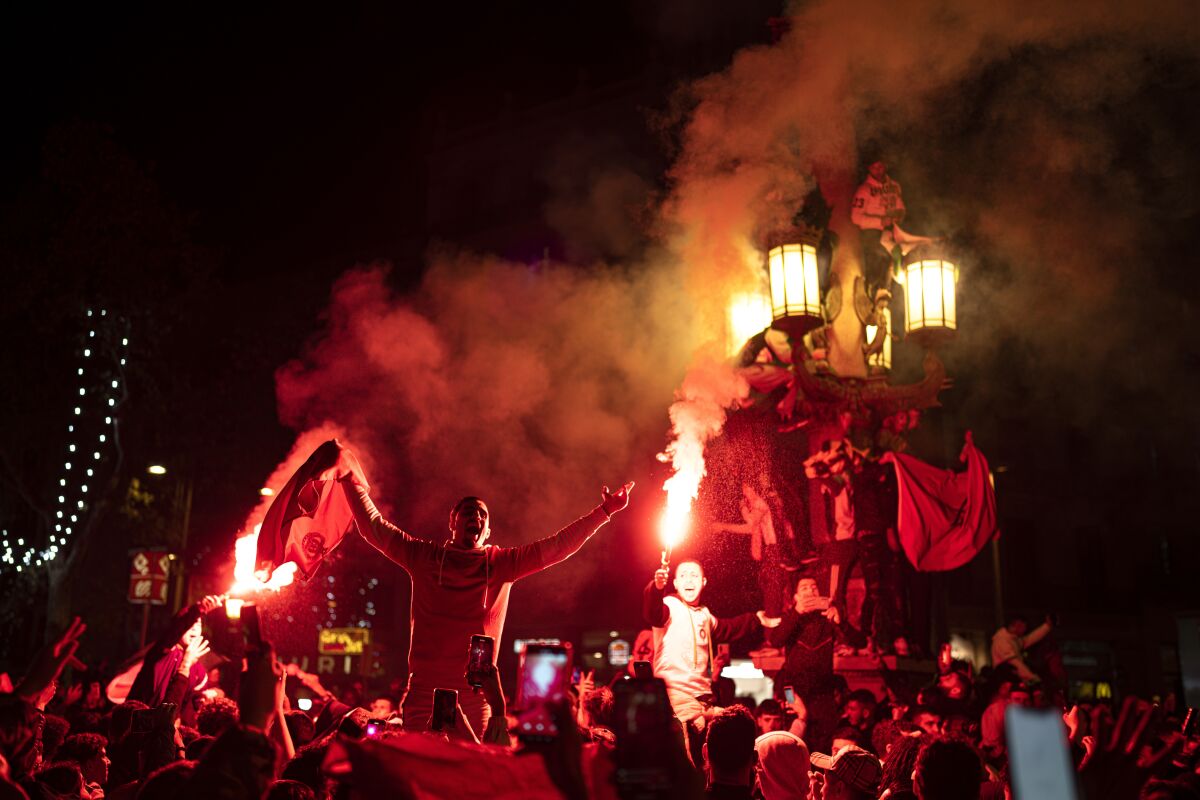 FILE - Morocco fans celebrate in Barcelona, Spain, Tuesday, Dec. 6, 2022. Morocco beat Spain on penalties in a round of 16 World Cup soccer tournament in Qatar. (AP Photo/Pau de la Calle, File)