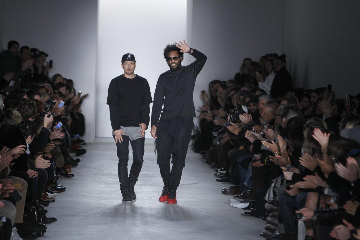 Public School's designers Dao-Yi Chow, left, and Maxwell Osborne hit the runway after their AW15 show during NYFW on Feb. 15, 2015. The winners of the CFDA's 2014 Menswear Designer of the Year Award, they are nominated in that category again for 2015 -- as well as in the Accessory Designer of the Year category.