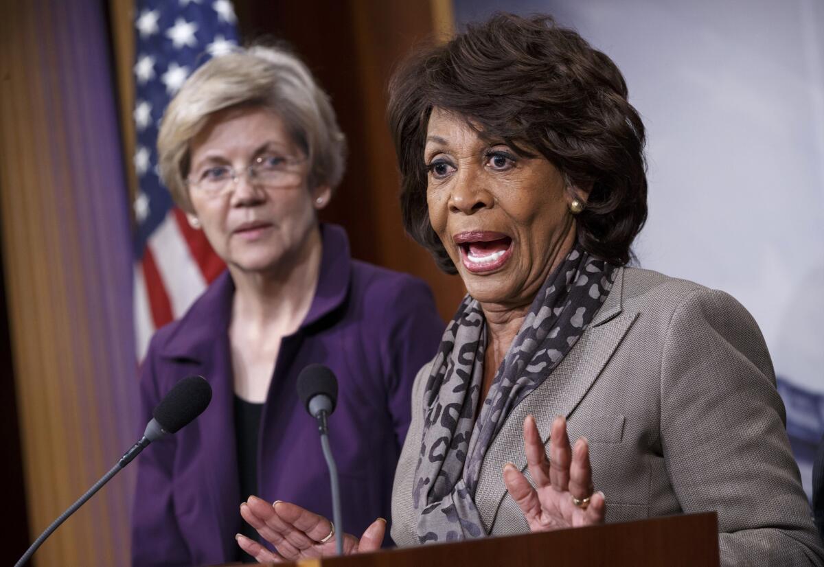 Sen. Elizabeth Warren (D-Mass.), left, and Rep. Maxine Waters (D-Los Angeles) appear at a December news conference. The two have been leading efforts to stop Republicans from making changes to the Dodd-Frank financial reform law.