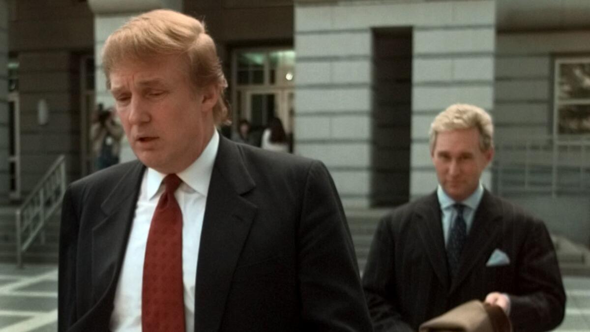 Roger Stone follows Donald Trump as they leave the federal courthouse in Newark, N.J., in 1999 after Trump's sister was sworn in as an appeals court judge.
