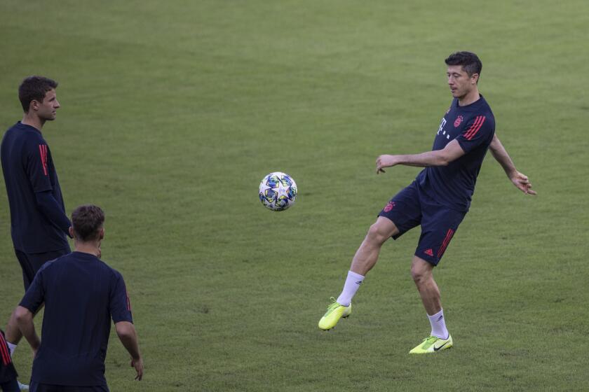 Bayern's player Robert Lewandowski warms up during a training session at Georgios Karaiskakis stadium in the port of Piraeus, near Athens, Monday, Oct. 21, 2019. Bayern will face Olympiakos in Athens, on Tuesday, Oct. 22 for a Champions League group B soccer match.(AP Photo/Petros Giannakouris)