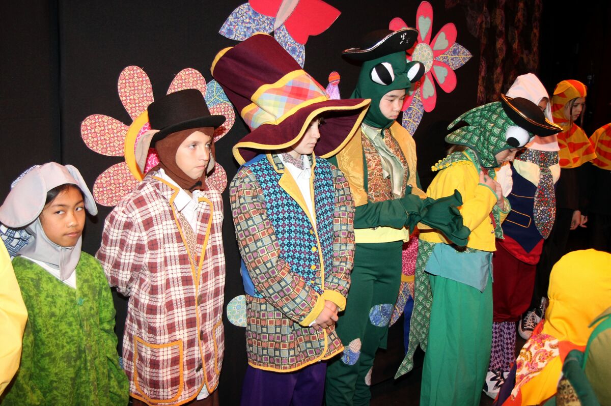 Children waiting to go on stage at the Poway Center for the Performing Arts during "Alice in Wonderland" last year.