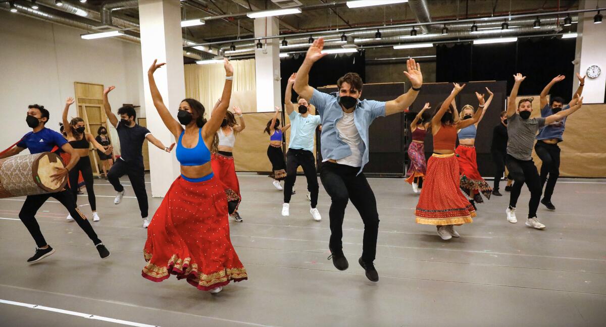 The cast of "Come Fall in Love — The DDLJ Musical" rehearse a dance scene at the Old Globe Theatre.