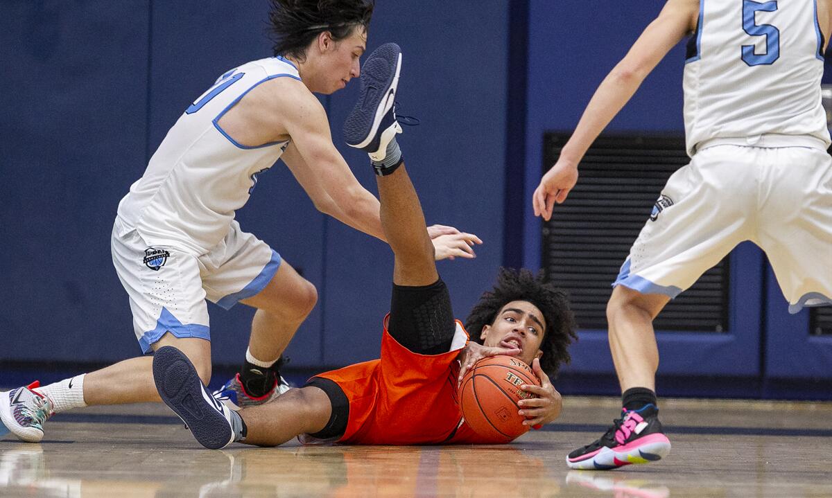 Pacifica Christian Orange County's Houston Mallette scrambles to get his hands on a loose ball before Corona del Mar's Matt DeCrona, left, does in a pool-play game of the CdM Beach Bash on Thursday.