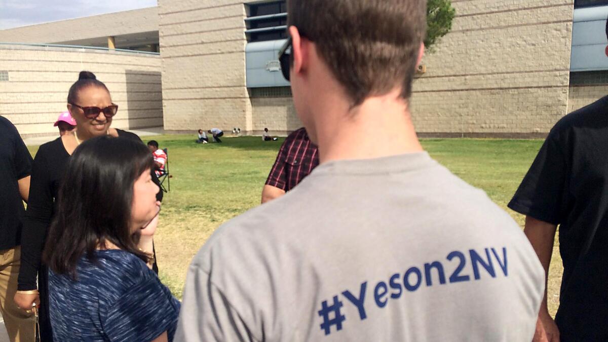 Spenser Sullivan, a student at UNLV, hands out fliers supporting Question 2 at a rally in Las Vegas where President Obama was speaking.