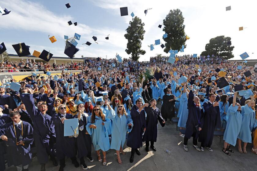 Graduates celebrate by tossing their caps into the air during the conclusion of Marina High School's commencement ceremony in Huntington Beach on Thursday, June 14.