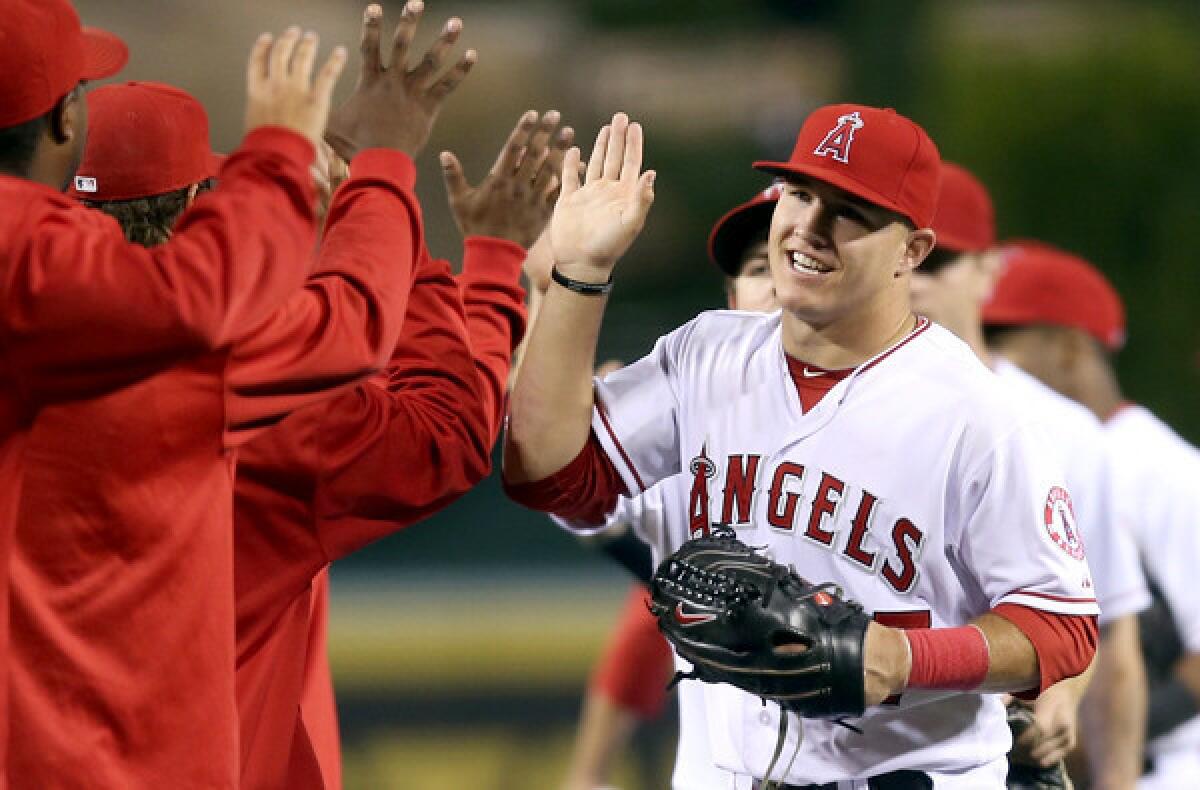 Angels outfielder Mike Trout celebrates with his teammates following a 4-3 victory over the Dodgers on Wednesday.