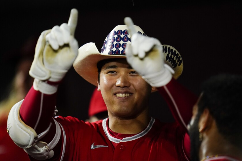Shohei Ohtani wears a cowboy hat in the dugout while celebrating a solo home run during a loss to the Baltimore Orioles.