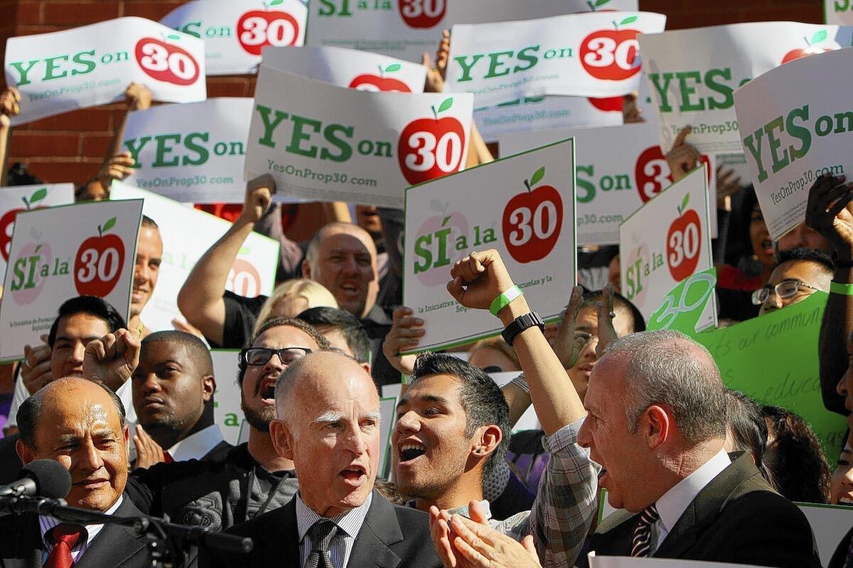Gov. Jerry Brown, center, at a 2012 rally for Proposition 30, a temporary tax increase that voters approved. On his watch, the state’s finances have greatly improved, but big challenges remain.