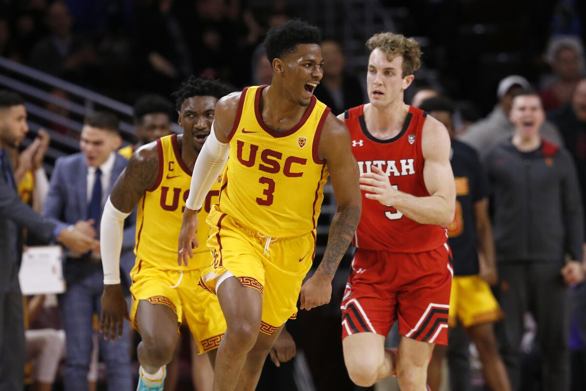 USC guard Elijah Weaver (3) celebrates after scoring a basket putting the Trojans in the lead against Utah in the second half at the Galen Center on Thursday.