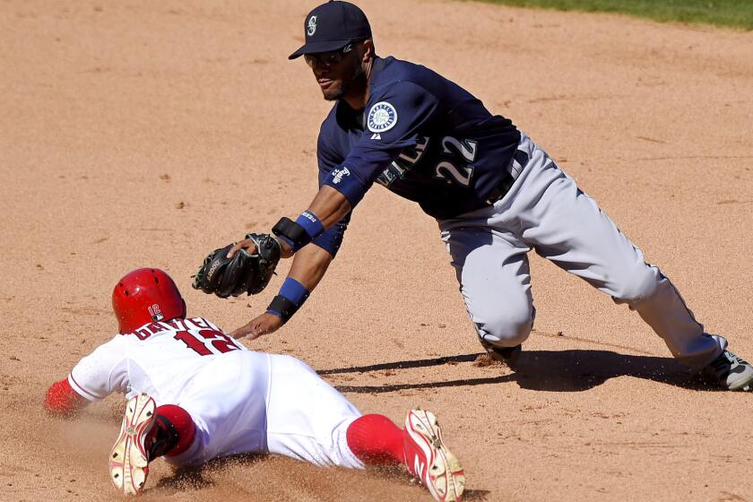 Angels second baseman Johnny Giavotella slides safely into second base with a double against Mariners second baseman Robinson Cano for a double in the eighth inning Saturday afternoon.